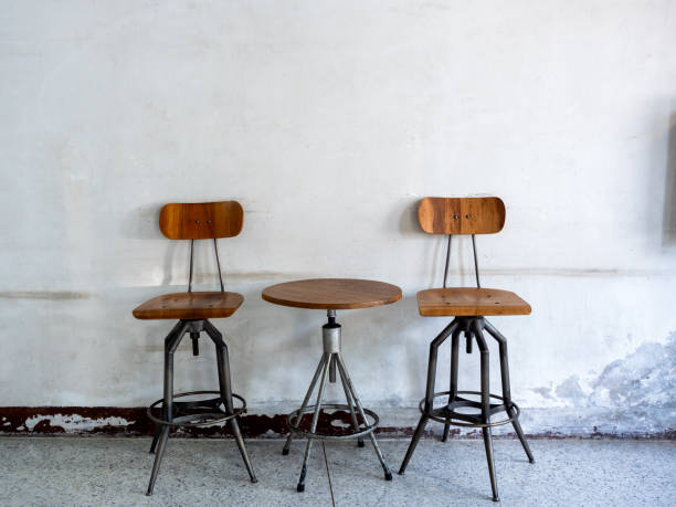 A photo of a retro and fashionable chair and a round desk.