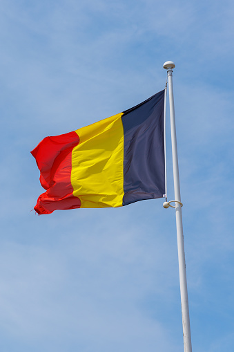 German flag waving in the wind on blue sky