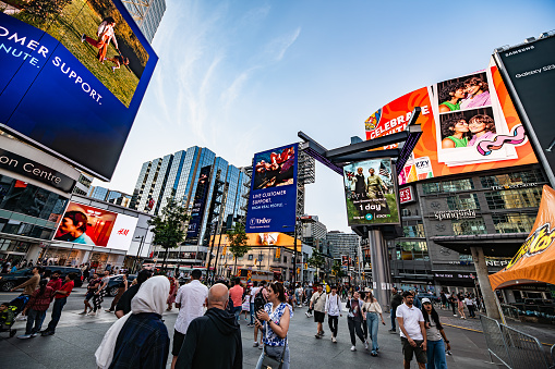 Younge-Dundas square in toronto with the crowd on the sidewalk and advertisements visible on the buildings