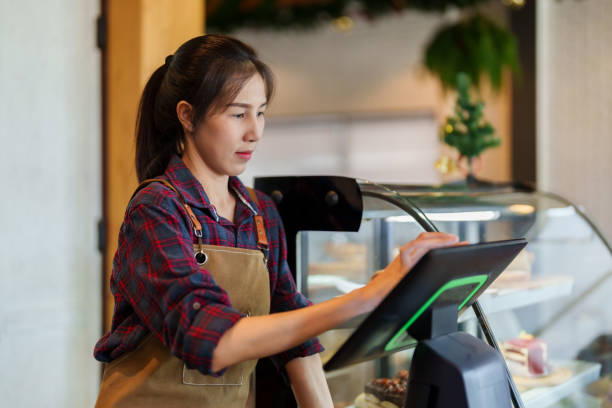 istock Portrait owner cafe bakery standing behind counter inside shop, close bakery, charging at store's cash register it's also machine that can accept orders in front counter, was focusing on that machine. 1506561104
