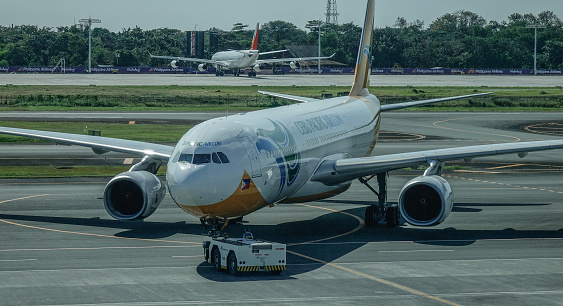 Manila, Philippines - Dec 21, 2015. Passenger airplane docking at NAIA Airport in Manila Philippines. In 2017, NAIA handled a record-breaking annual passenger traffic of 42 millions.