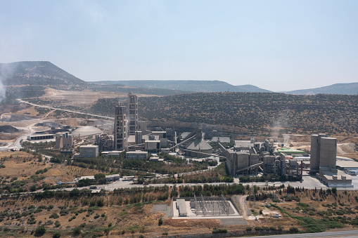 Aerial view of huge industrial factory. Structures of cement producing plant.