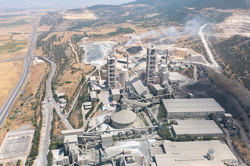 Aerial view of industrial factory. Structures of cement producing plant.