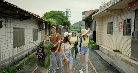 A group of friends walking on the streets of a traditional town in Taiwan