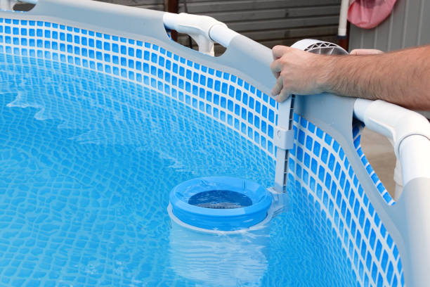 istock Man cleans skimmer for the frame pool. Contaminated pool cleaning concept 1506710468