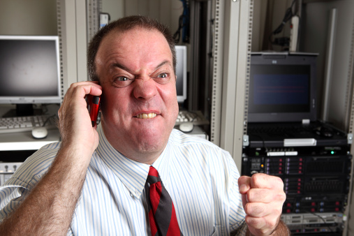 A male IT Worker, looks Angry.