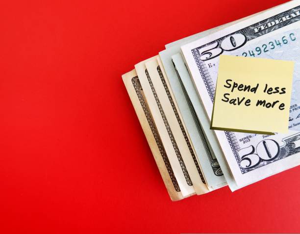 istock Dollars cash money on copy space red backgroud with note written SPEND LESS SAVE MORE, financial planning to achieve financial independence by spend less than earning 1506774447