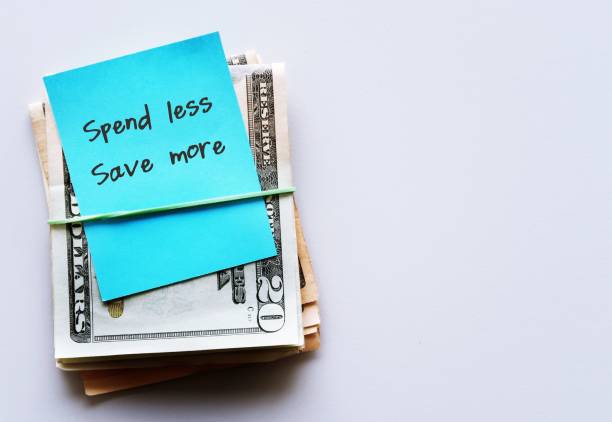 istock Dollars cash money on copy space white background with note written SPEND LESS SAVE MORE, financial planning to achieve financial independence by spend less than earning 1506786307