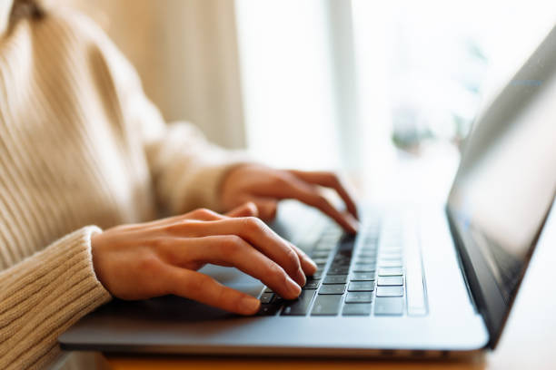istock Female hands working on a laptop, close-up. Freelance, online course, remote work and lifestyle concept. 1506787989