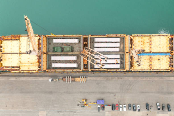 istock Top view Unloading operation of project  cargo with port heavy lift cranes A crane on a large cargo ship docks loading a new diesel-electric locomotive.  at Laem Chabang Port 1506792351