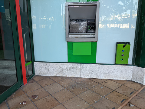 Broken glass of red bank ATM