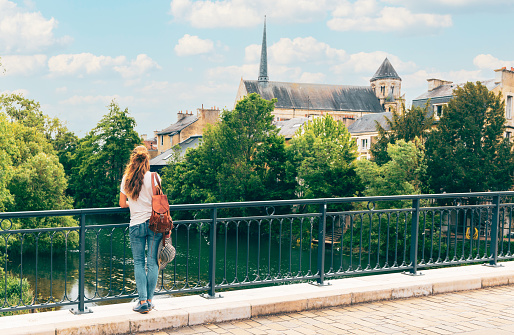Woman on the bridge in Poitiers city- France- Poitou Charente