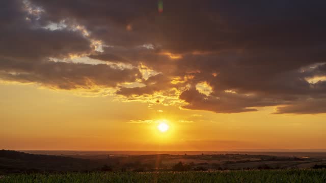 Sunrise over a field in an open rural landscape