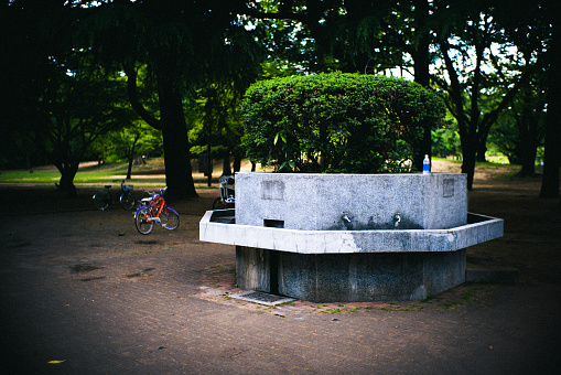 A drinking fountains in a park in downtown Tokyo.