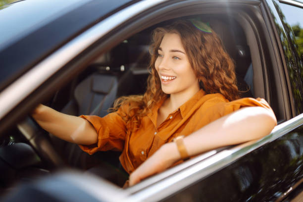 istock Smiling woman driving a car. 1506831313