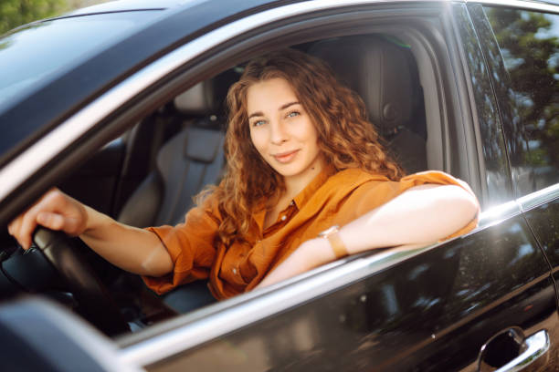 istock Smiling woman driving a car. 1506831318