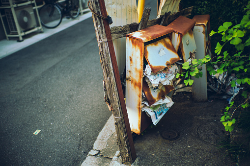 A post box in a dilapidated apartment in downtown Tokyo.