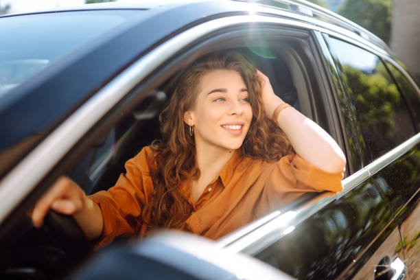 istock Smiling woman driving a car. 1506831334