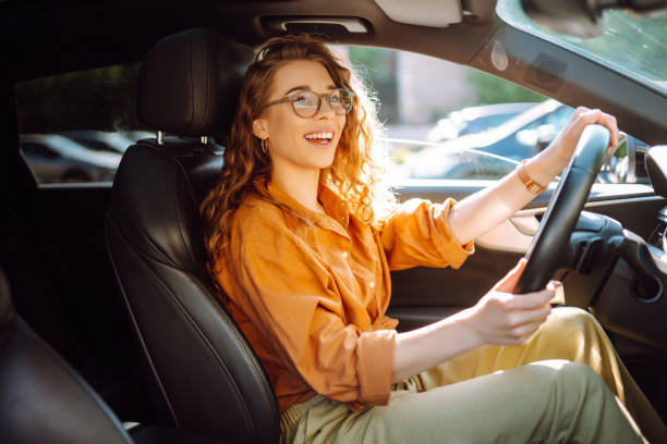 istock Smiling woman driving a car. 1506831335