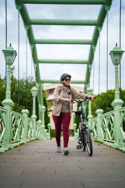 istock Woman pushing bike on bridge 1506832943