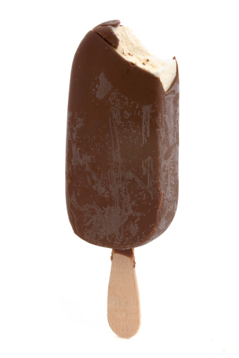 Chocolate covered ice-cream with missing bite over white