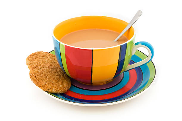 stripy чашка и блюдце с двумя печенье на белом - two objects cup saucer isolated стоковые фото и изображения