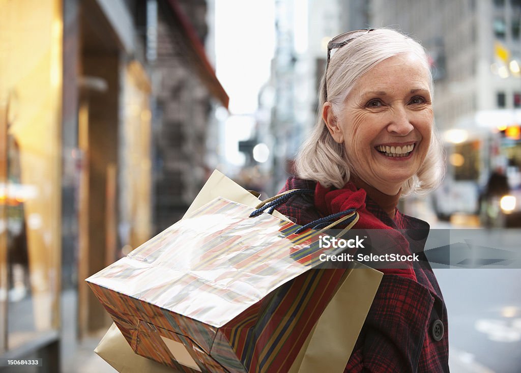Старший Женщина держит сумки покупок - Стоковые фото Ходьба по магазинам роялти-фри