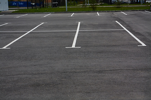 Photo of empty parking lot without cars. Road marking. Traffic Laws.