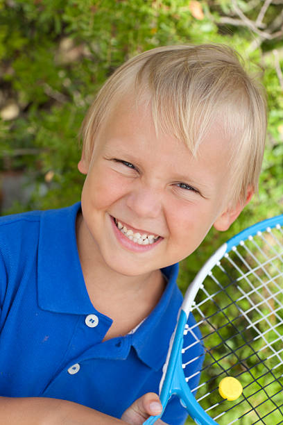 istock small boy with tennis racket 150685323