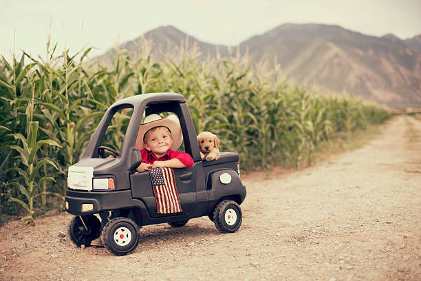 American Kid A young boy is ready to work hard on the farm. american dog stock pictures, royalty-free photos & images
