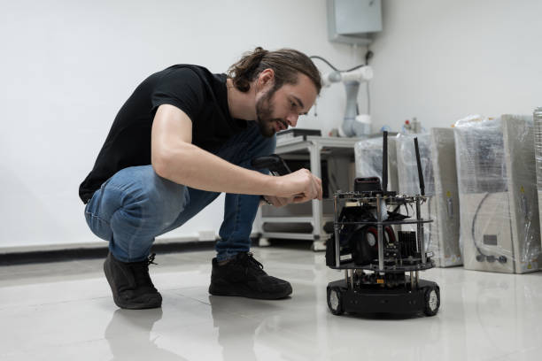 istock Automated manufacturing industries. Innovative technology. Male engineer inspecting quality of compact desktop robotic arm for manufacturing lines in workshop. Smart automation tasks concept 1506890527
