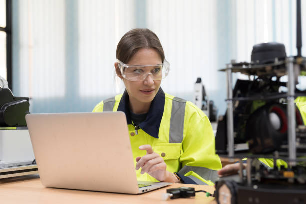 istock Automated manufacturing industries. Innovative technology. Female engineer inspecting quality of compact desktop robotic arm for for manufacturing lines in workshop. Smart automation tasks concept 1506890815