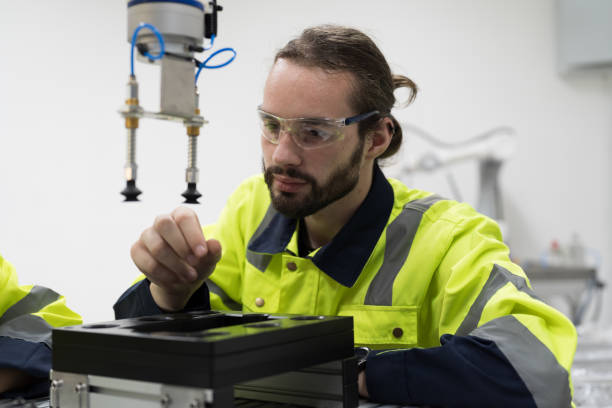 istock Automated manufacturing industries. Innovative technology. Male engineer inspecting quality of compact desktop robotic arm for for manufacturing lines in workshop. Smart automation tasks concept 1506891072