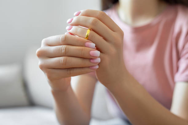 istock Woman taking off wedding ring 1506919544