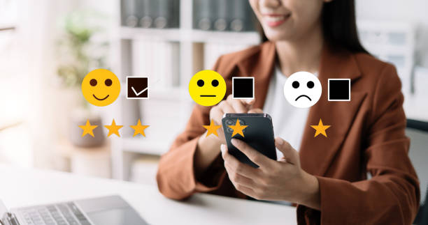 istock Woman holding a digital smartphone with checkboxes rating smiley faces excellent for Satisfaction Survey, Happy Client Customer Experience concept. 1506928122