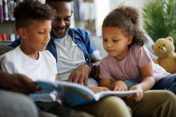 istock Father reading book to kids. Children education and development concept. 1506936882