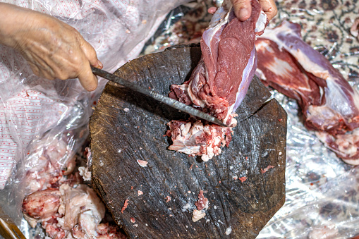 Senior woman cutting steak