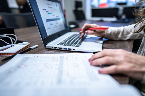 Woman's hand working on the laptop in the office