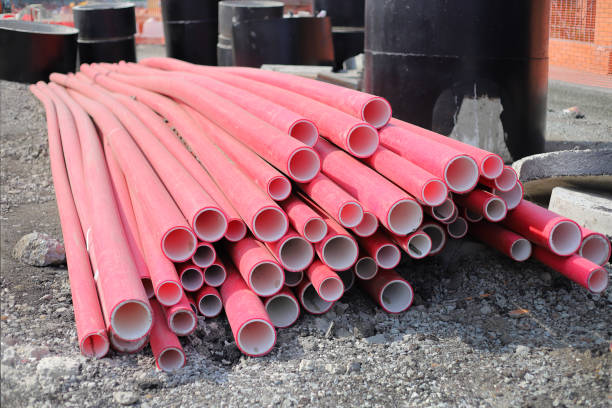 istock Red corrugated pipe for wire at construction site. Cable conduit for trenchless installations 1506973935