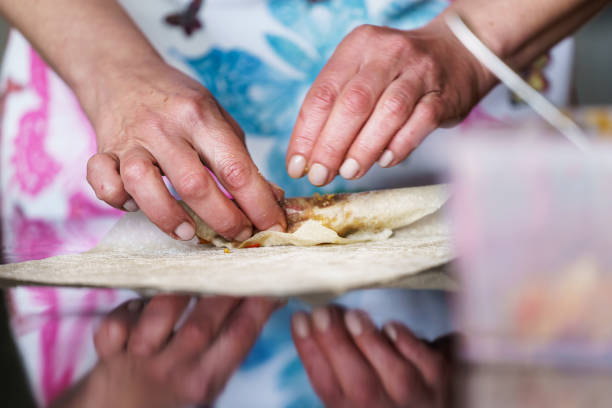 istock A woman is making a large number of vegetable rolls. 1506986270