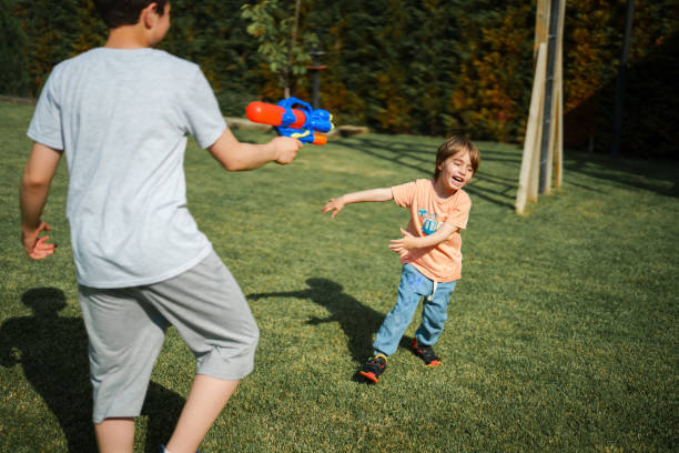 istock Kids playing with squirt gun, weekend activities at the backyard 1506989652