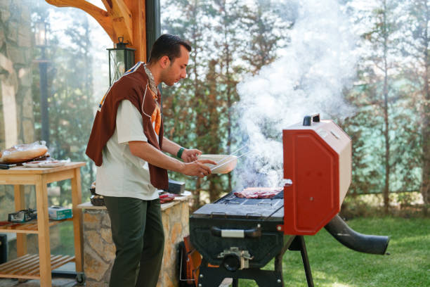 istock Man cooking sausage on bbq grill, weekend activities at the backyard 1507003267