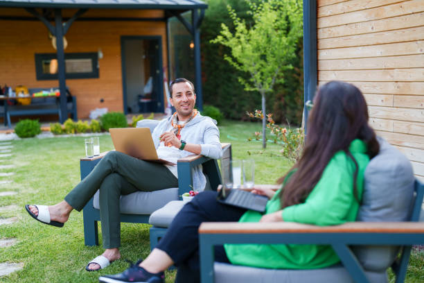 istock Couple using laptop at home in the backyard 1507008717