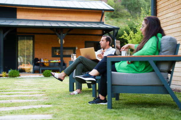 istock Couple using laptop at home in the backyard 1507008720