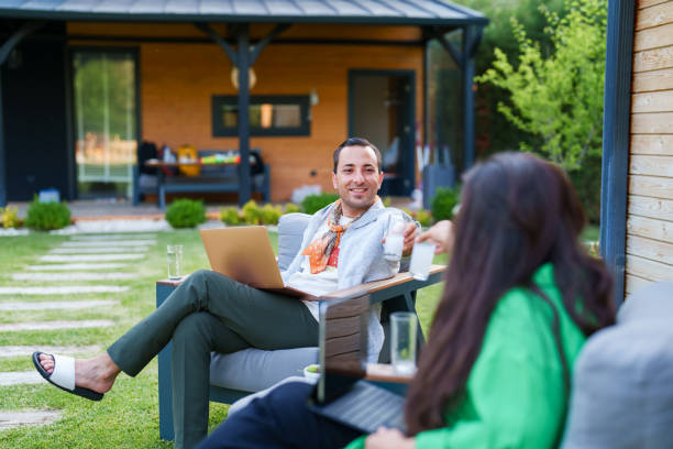 istock Couple using laptop at home in the backyard 1507011837