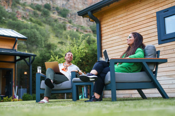 istock Couple using laptop at home in the backyard 1507013087