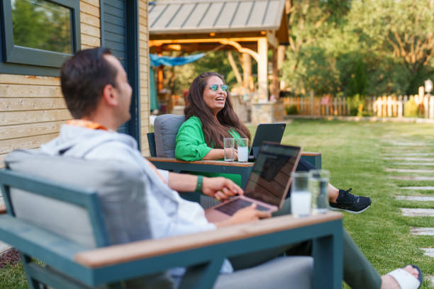 istock Couple using laptop at home in the backyard 1507013225