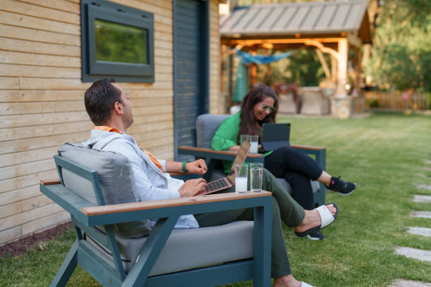 istock Couple using laptop at home in the backyard 1507013302