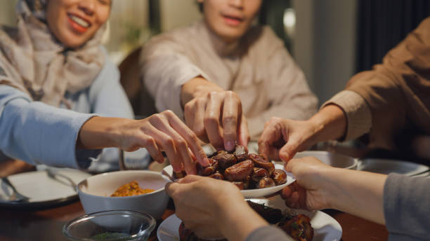Close-up dates fruit dish Eid Mubarak Muslim Asia family have Iftar dinner to break feast. Traditional food during Ramadan fasting month at home, The Islamic Halal Eating Drinking at modern Islam. stock photo