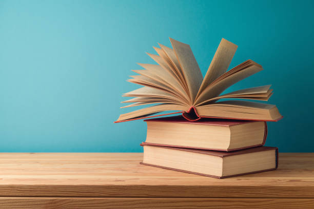 istock Books on wooden table over blue background. Back to school concept 1507047182
